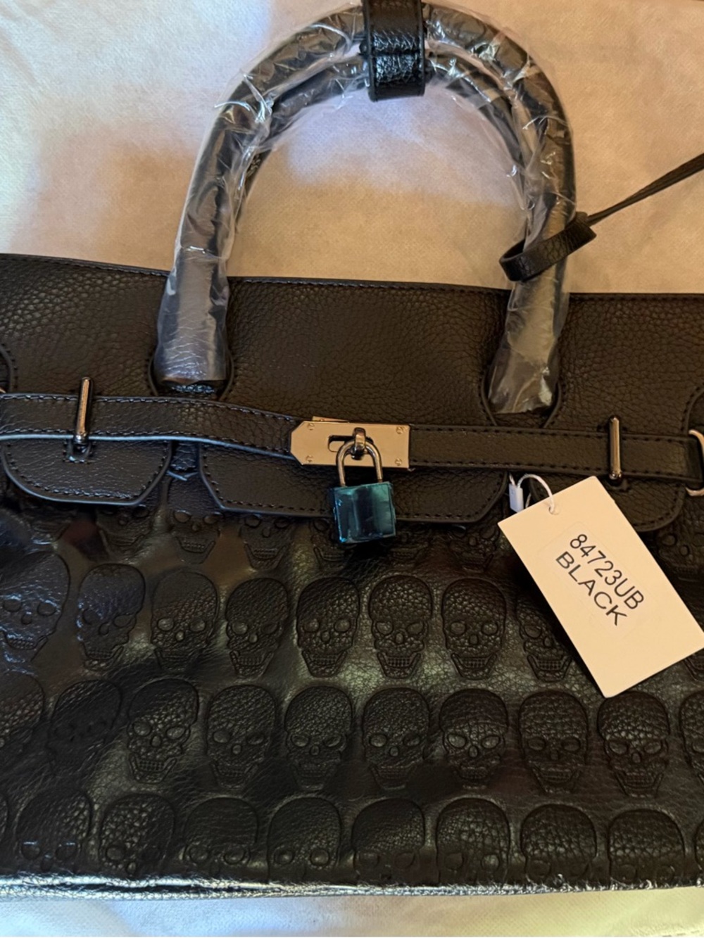 Black Skull-Embossed Leather Tote Handbag with Lock Accent with Shoulder Strap
